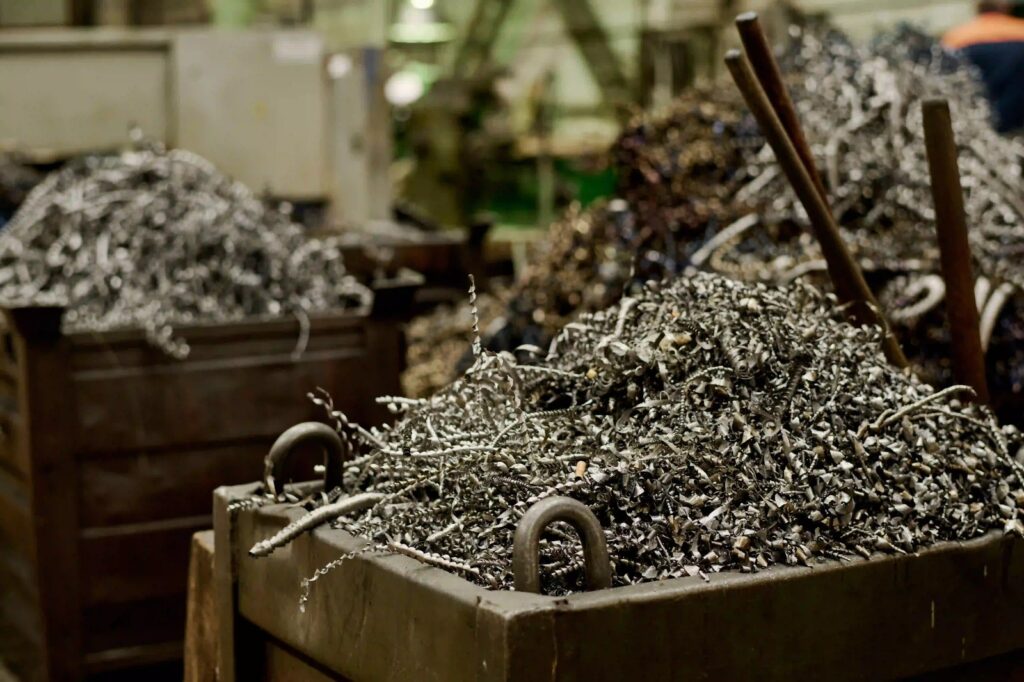 Metal shavings in large bins at a recycling facility, showcasing services by scrap metal recyclers Wilmington, DE, A1 Dumpster Rental.